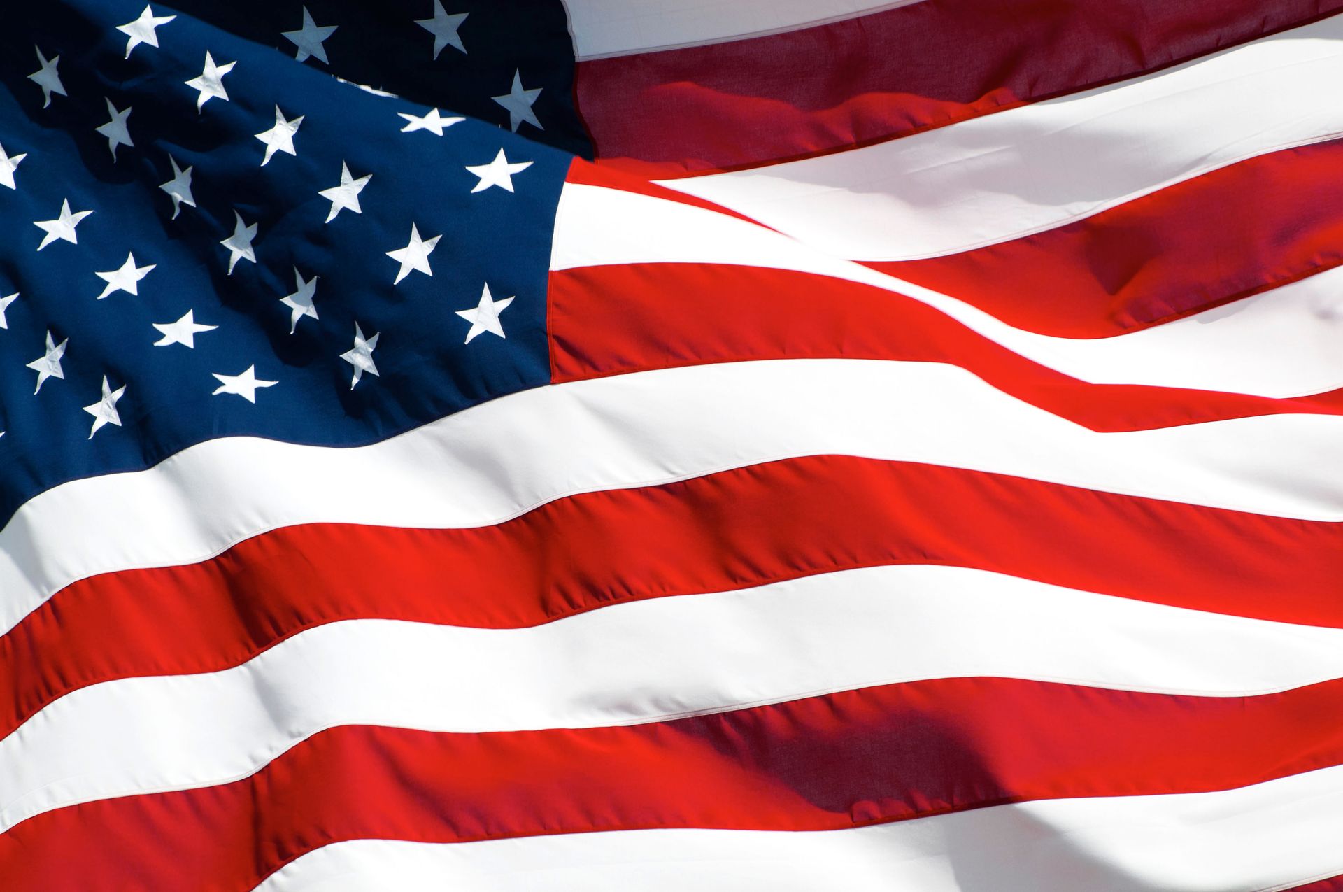 Waving American flag with red, white, and blue stripes and stars